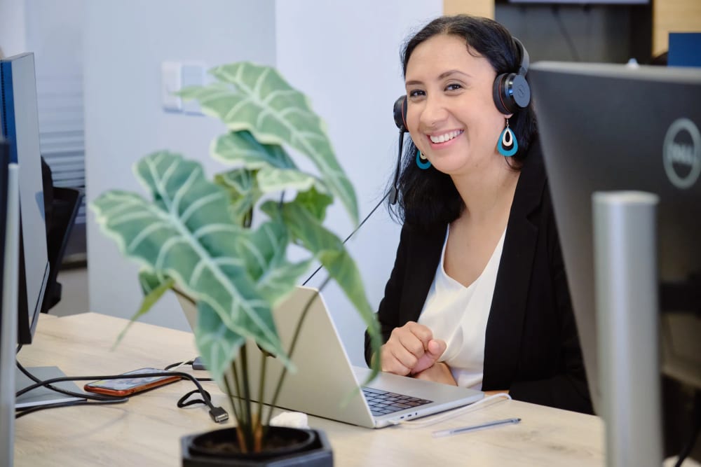 LevelUp HCS recruiter at her laptop with headset, smiling, Century City, Cape Town