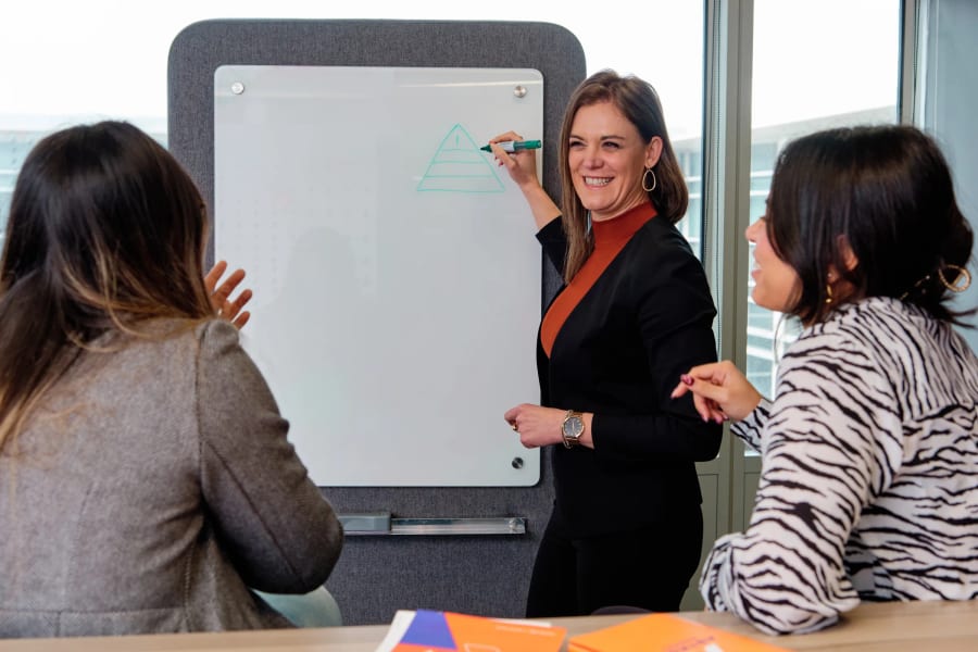 Working at the whiteboard with two colleagues, Astron Energy, Cape Town