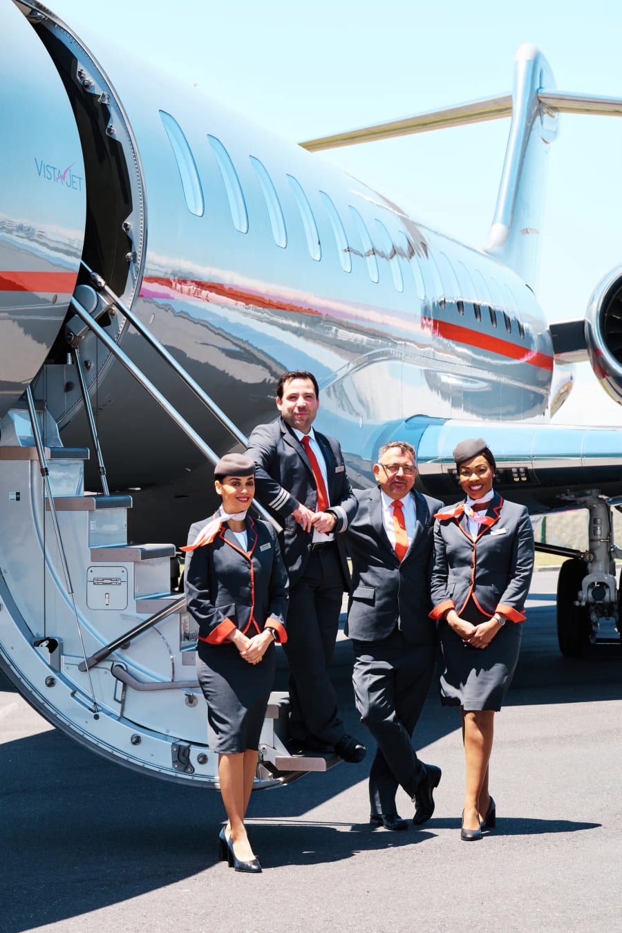 VistaJet cabin crew walking down the airstairs on the apron, Cape Town