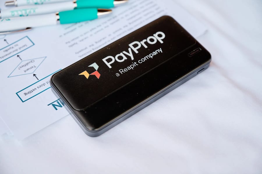 Close-up of a PayProp card reader resting on printed notes, Hazendal Wine Estate, Stellenbosch