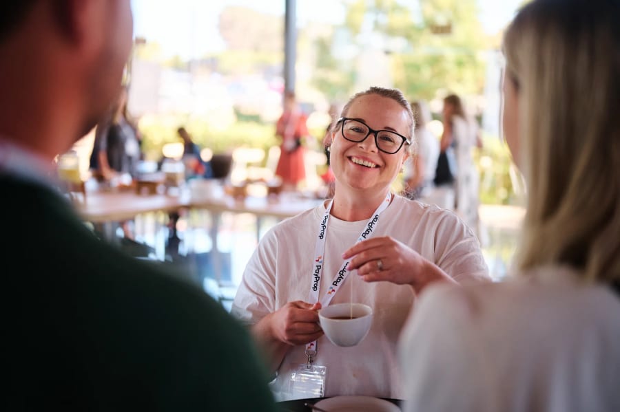 Delegates talking over coffee on the terrace, PayProp roadshow, Hazendal Wine Estate, Stellenbosch