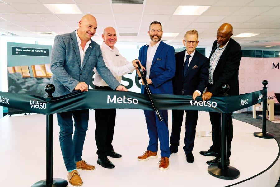 Five executives cutting the ribbon together to open a new corporate office, Cape Town