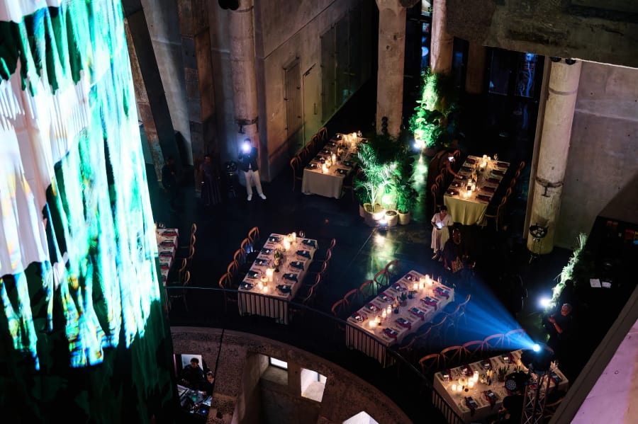 Dinner tables, palms and stage lighting seen from above in the Zeitz MOCAA silo, Cape Town