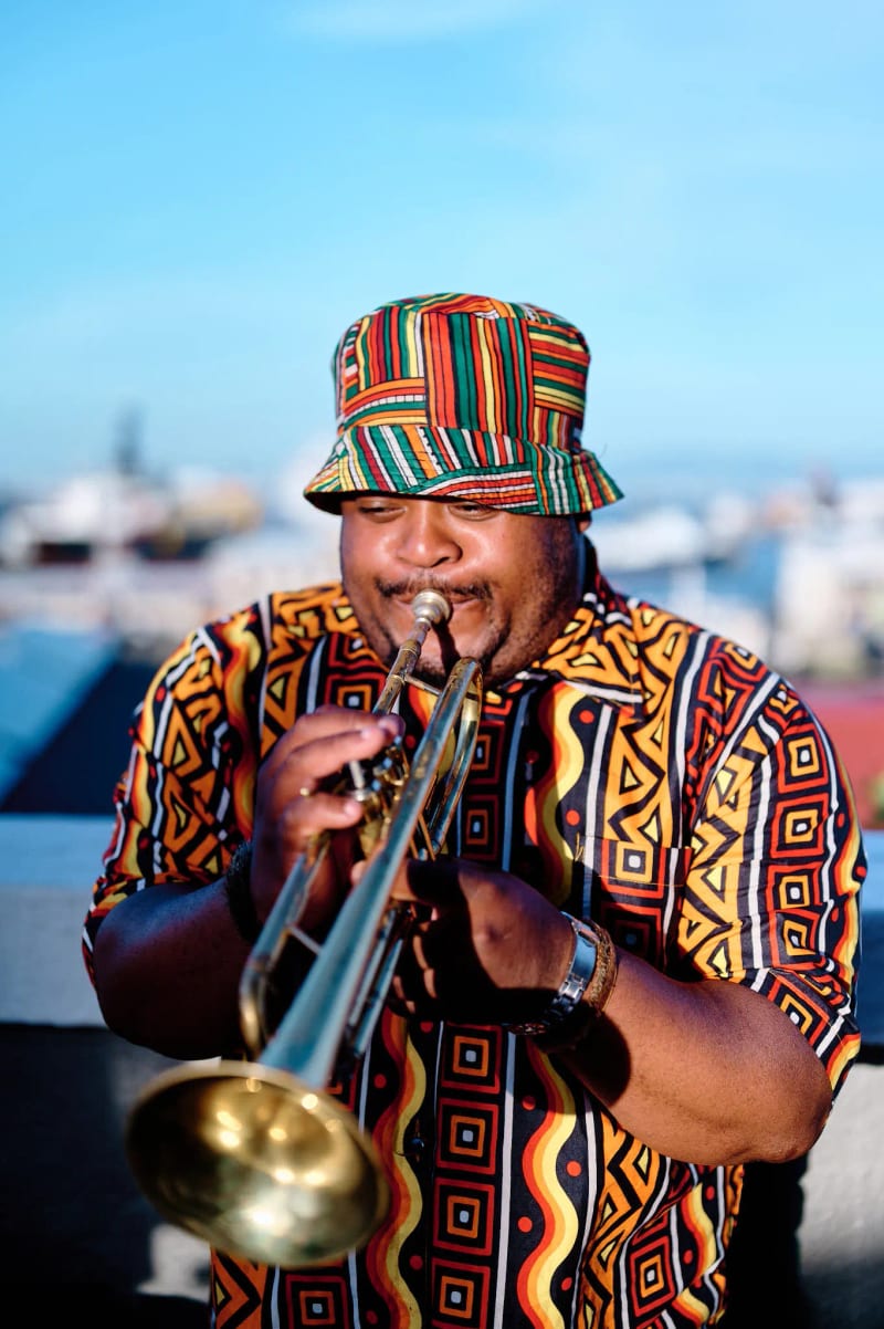 Trumpeter performing at a rooftop reception overlooking the harbour, Cape Town