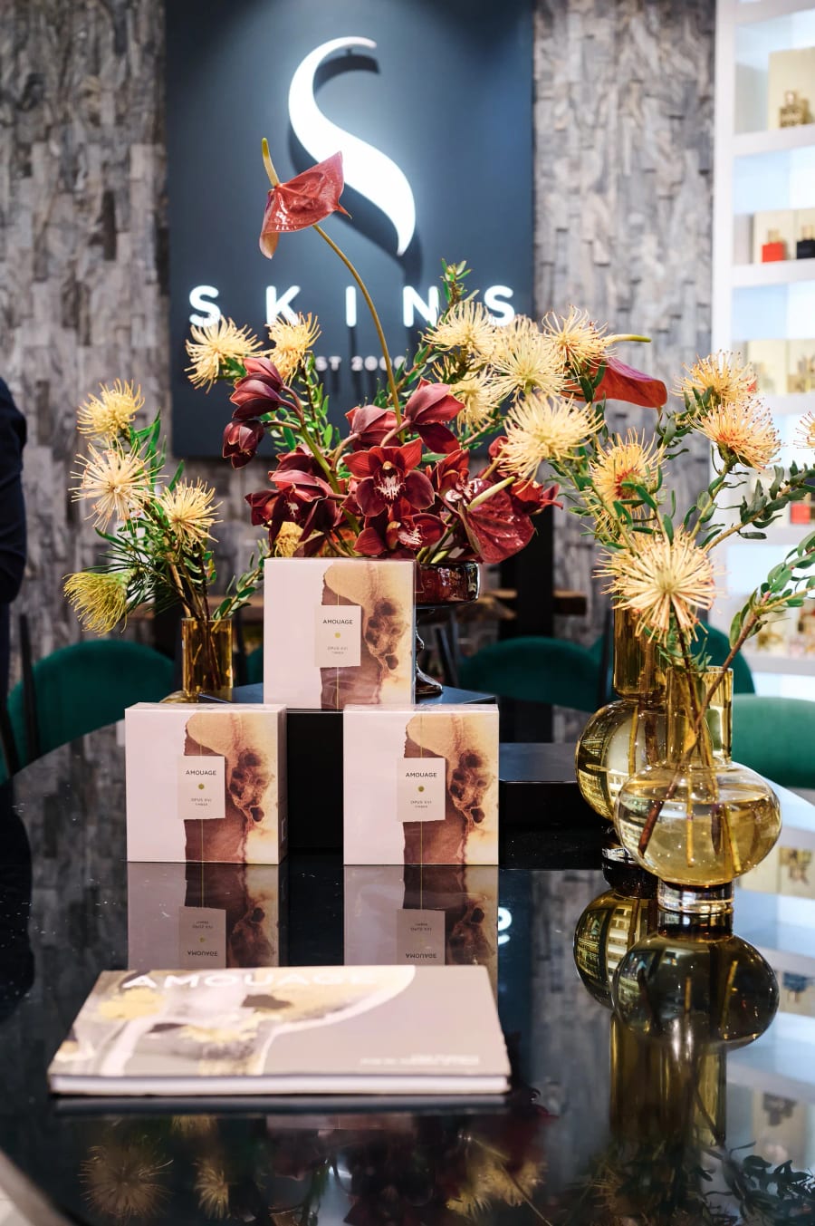 Skins product display plinth dressed with proteas at the Amouage launch, Cape Town
