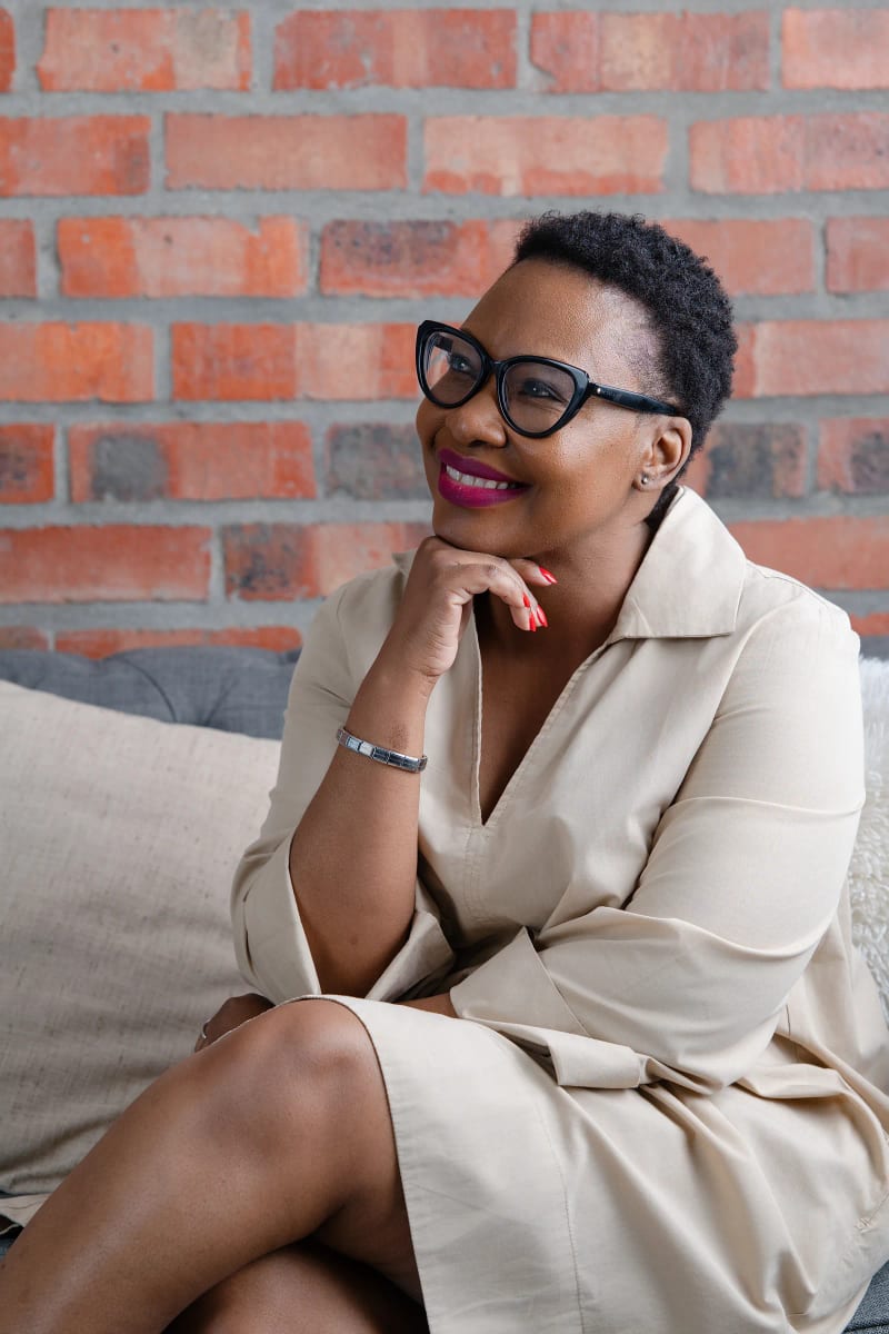 Personal branding portrait, Cape Town, a professional seated in a brick-walled loft