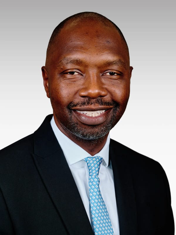 Executive headshot of a man smiling against a white studio background, Woodstock