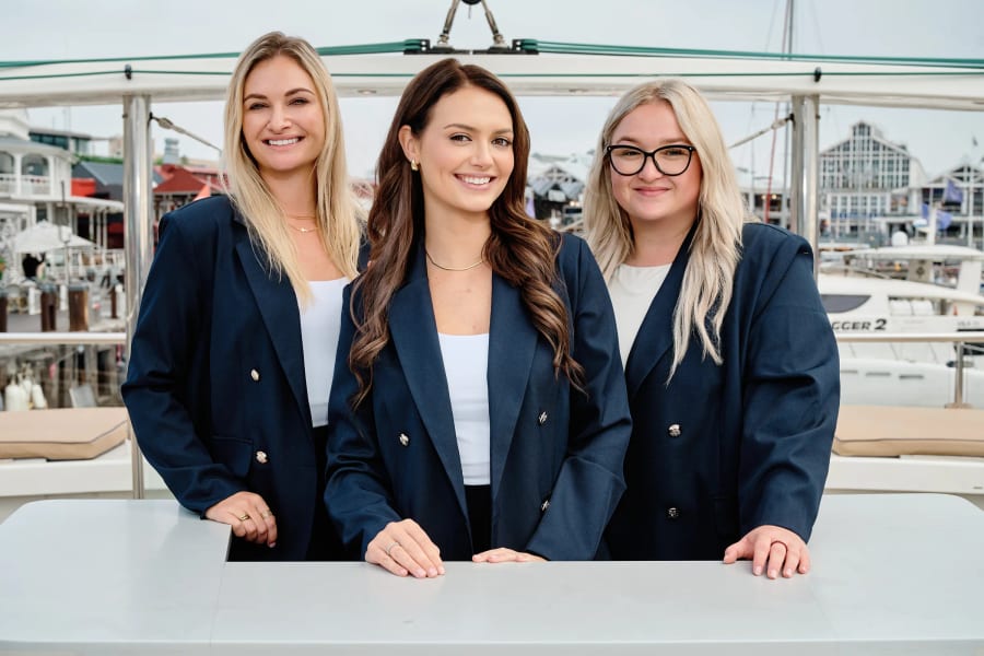 Three colleagues photographed together at the marina, Cape Town