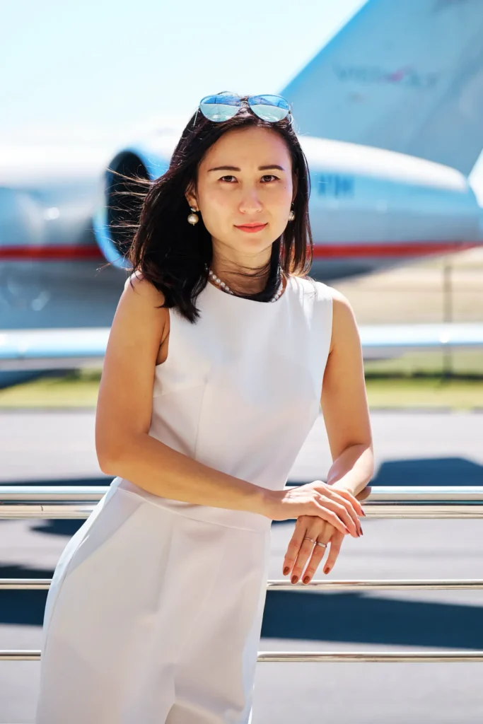 Three-quarter length portrait of the VistaJet Vice President for Marketing with the VistaJet aircraft in the background