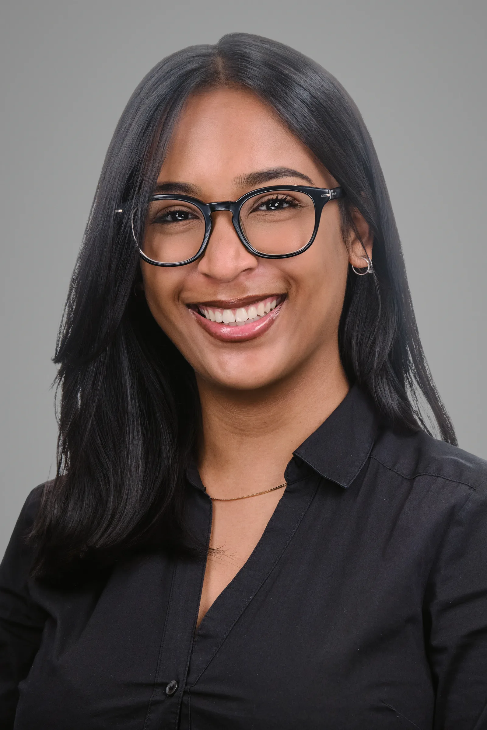 Corporate headshot of a LevelUp HCS team member wearing glasses, grey background, Cape Town