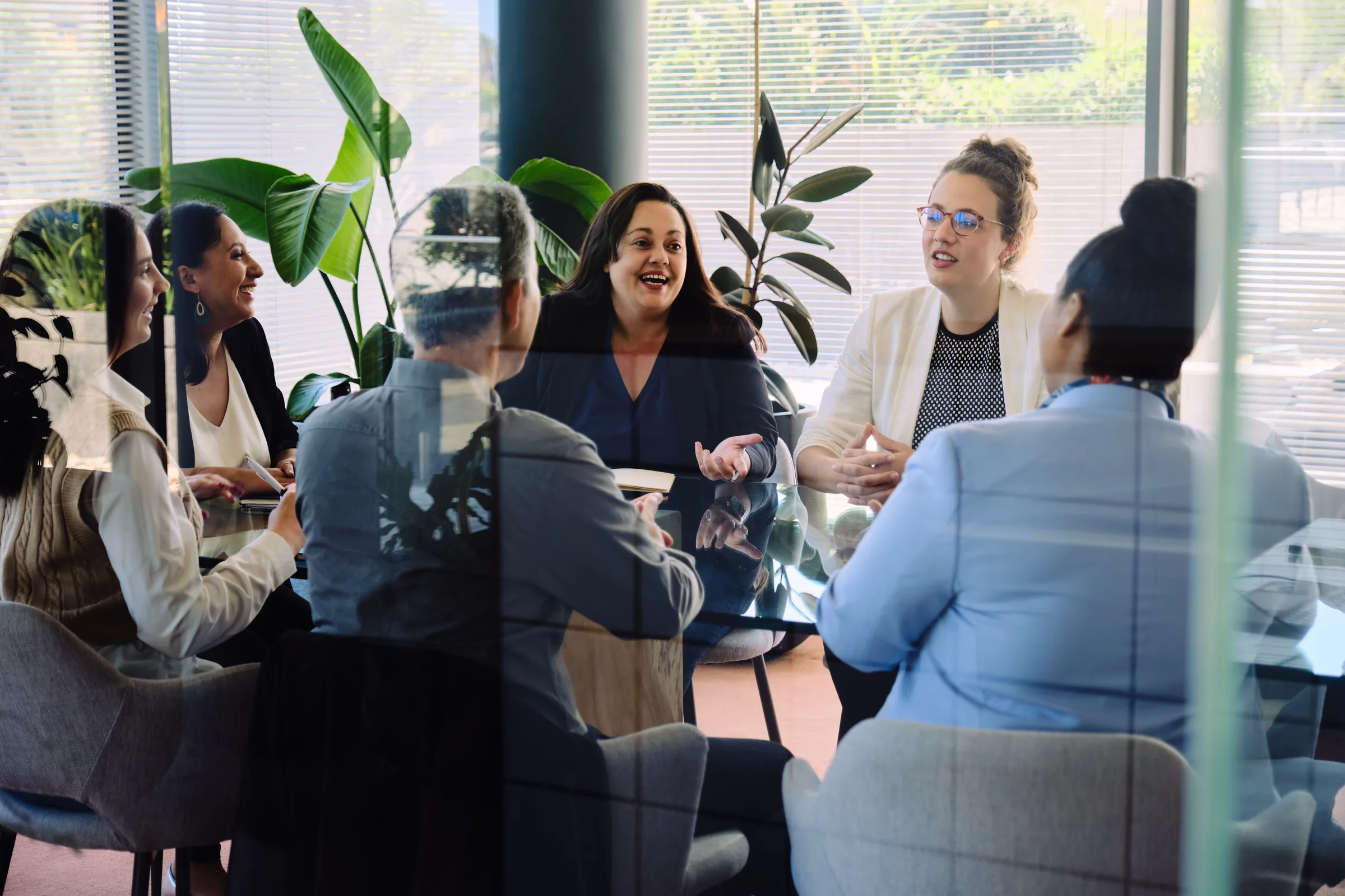 LevelUp HCS team in discussion around a meeting table, viewed through a glass partition, Century City, Cape Town