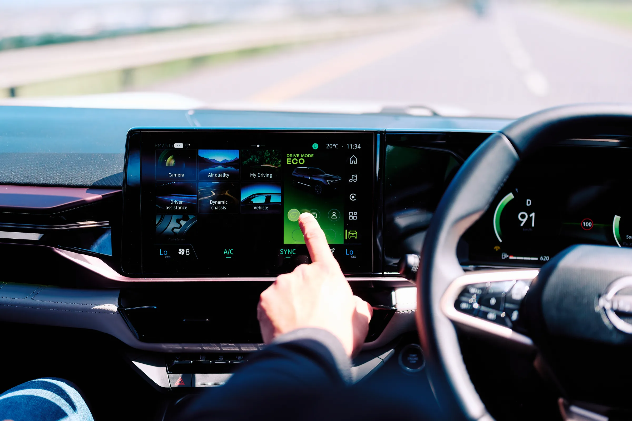 A hand reaching for the centre touchscreen inside a launch vehicle, Hazendal Wine Estate, Stellenbosch