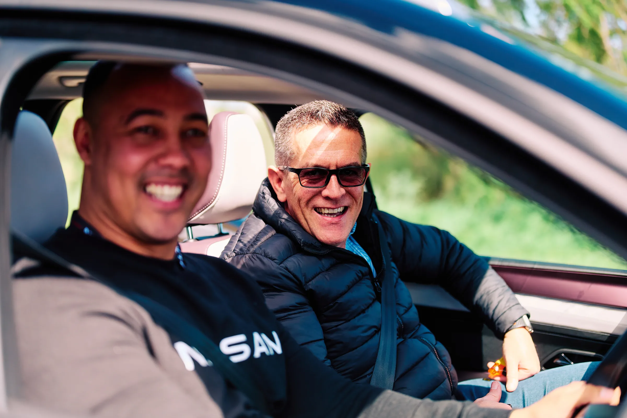 Two guests talking in the front seats during a drive session on the launch route, Cape Winelands