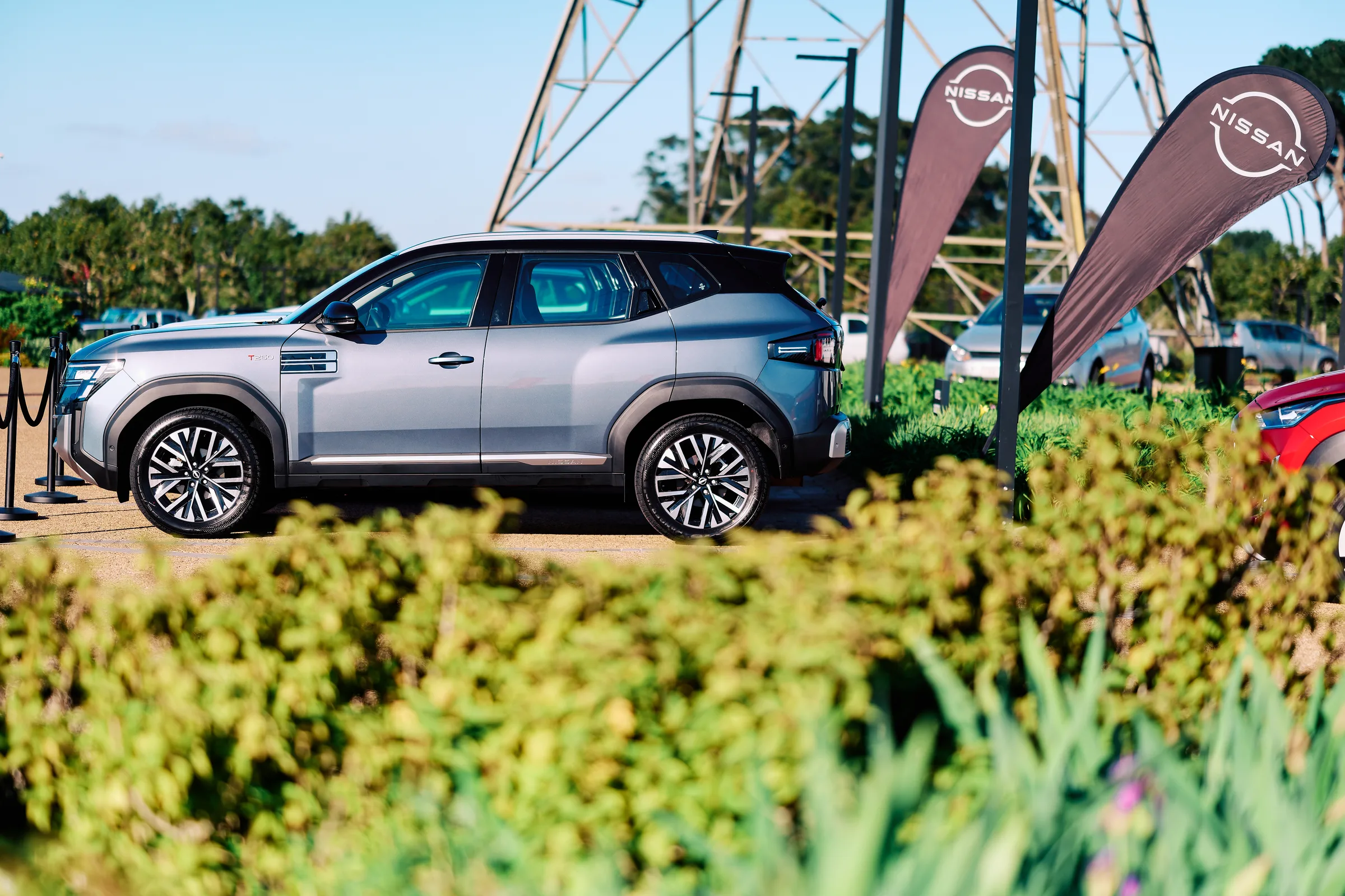 Launch vehicles parked on the lawn with branded flags and the estate behind, vehicle launch at Hazendal Wine Estate, Stellenbosch