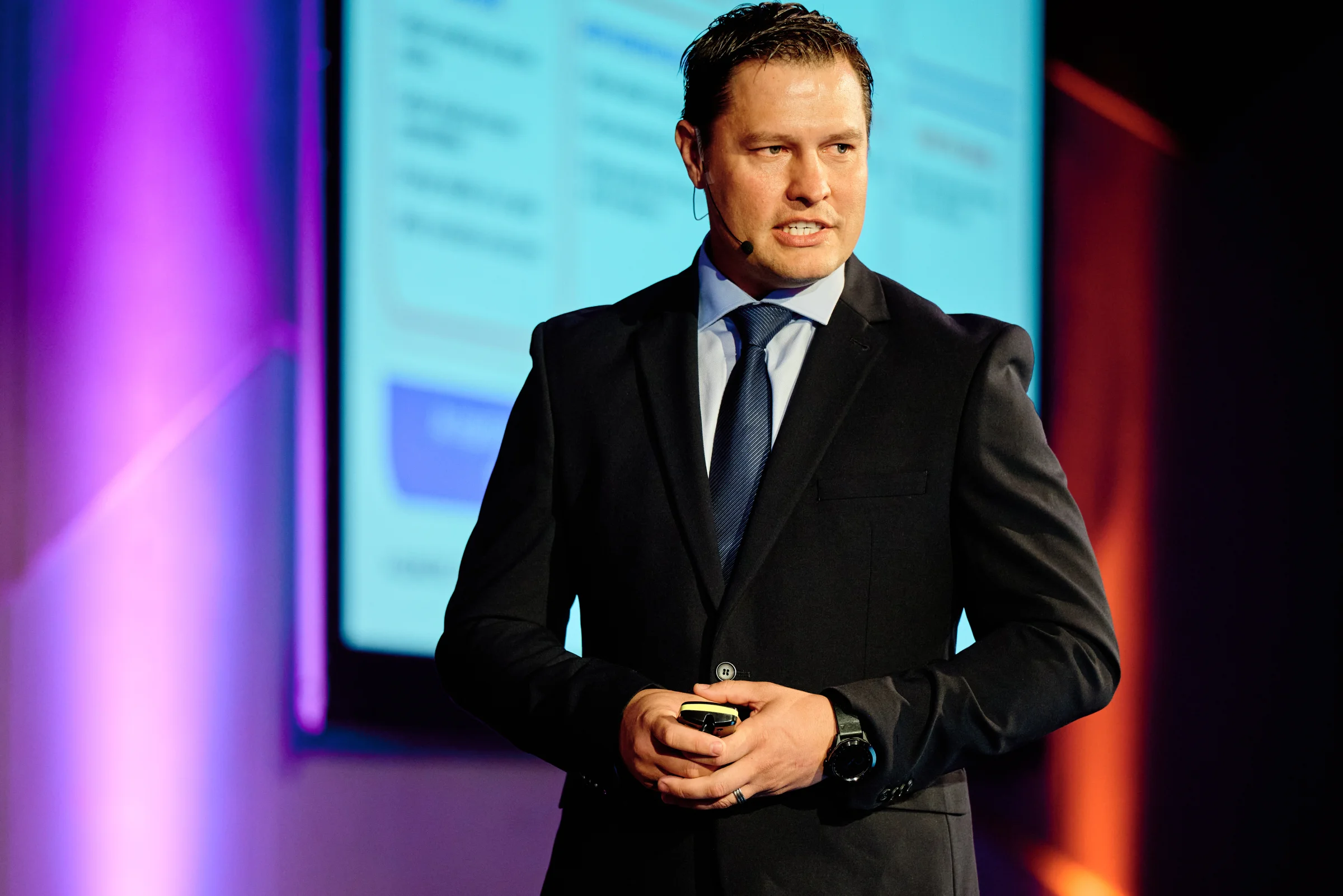 Speaker presenting on stage at a corporate conference, Cape Town