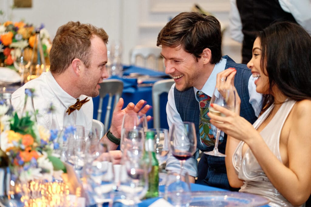 Guests sharing a laugh during a corporate gala dinner in Cape Town — authentic, professional event photography.