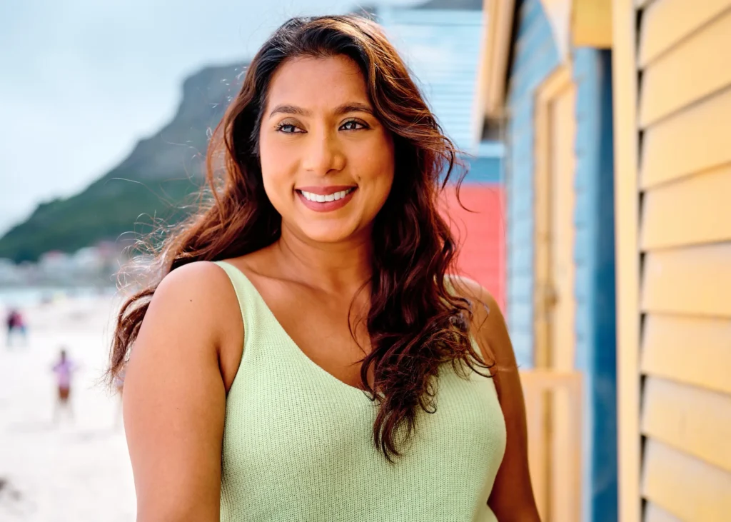 Commercial lifestyle photography in Cape Town: A vibrant, high-resolution portrait of a smiling woman, showcasing professional-grade composition and outdoor lighting.