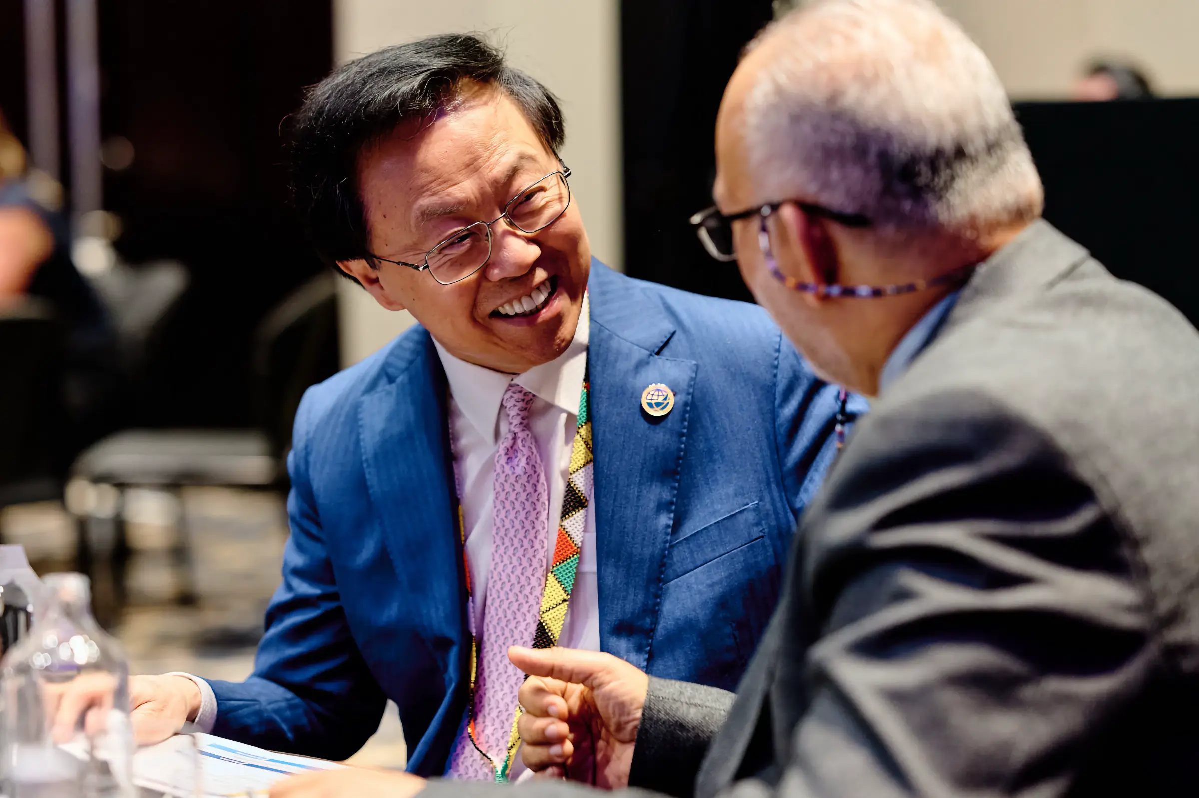Conference Photographer Cape Town: Candid photograph of a laughing audience at a corporate conference in Cape Town, documenting authentic engagement and event energy by Jürgen's Photography.